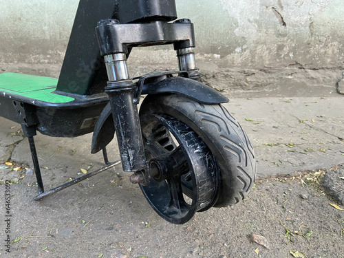 Fototapeta Naklejka Na Ścianę i Meble -  The front wheel tire of an electric scooter came off, damage and repair of urban transport after rental