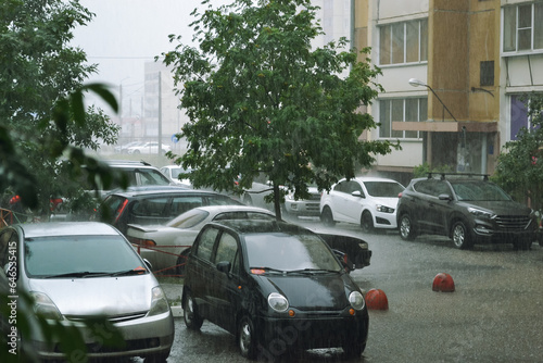 Cars parked in the yard under heavy rain