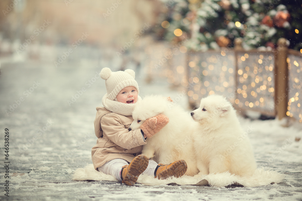 Little girl in beige winter clothes on Christmas fair eating lollipop with little white dog samoyed Little girl in beige winter clothes on Christmas fair eating lollipop with little white dog samoyed