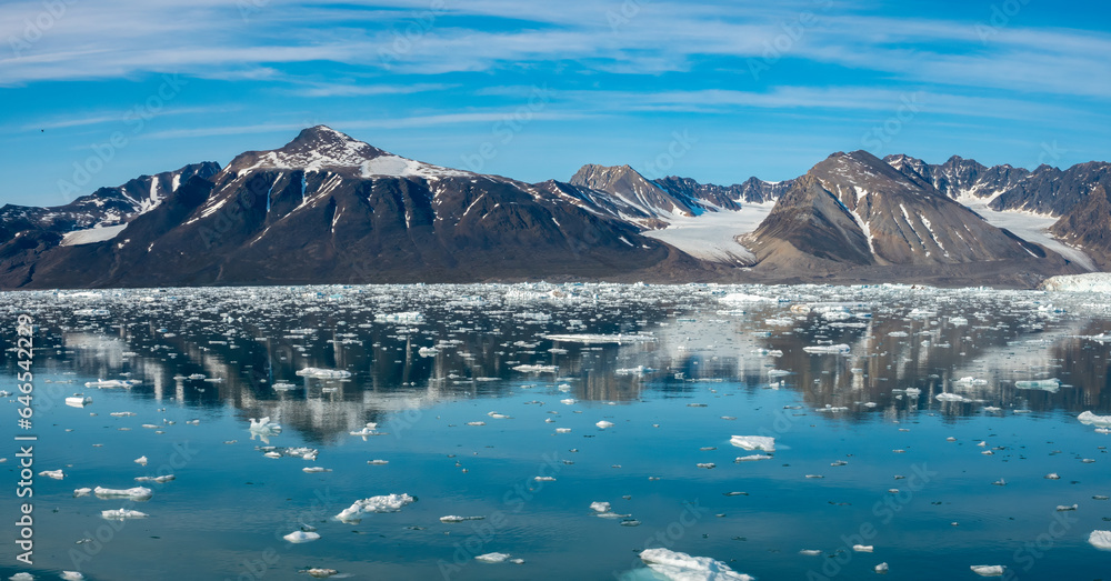 Stunning landscapes with jagged mountain peaks, glaciers and icebergs along the shores of the Liefdefjorden, Northern Spitsbergen, Svalbard, Norway Stunning landscapes with jagged mountain peaks, glaciers and icebergs along the shores of the Liefdefjorden, Northern Spitsbergen, Svalbard, Norway