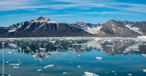 Stunning landscapes with jagged mountain peaks, glaciers and icebergs along the shores of the Liefdefjorden, Northern Spitsbergen, Svalbard, Norway