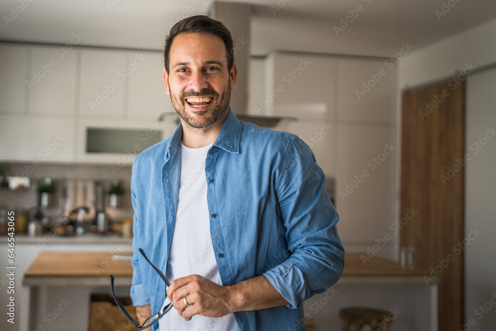 One adult man with eyeglasses stand at home happy smile One adult man with eyeglasses stand at home happy smile