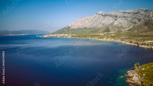 St. Elijah mountain rising high above town of Orebic on Peljesac peninsula  overlooking island of Korcula in the distance  photographed with drone