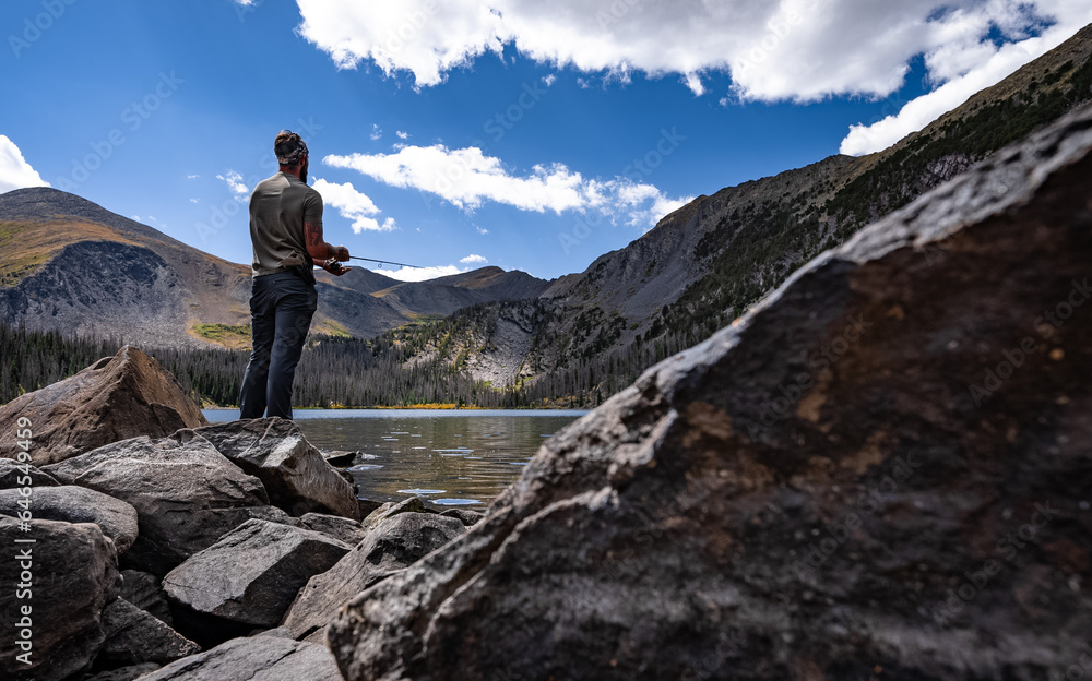person on a lake high mountain lake fishing