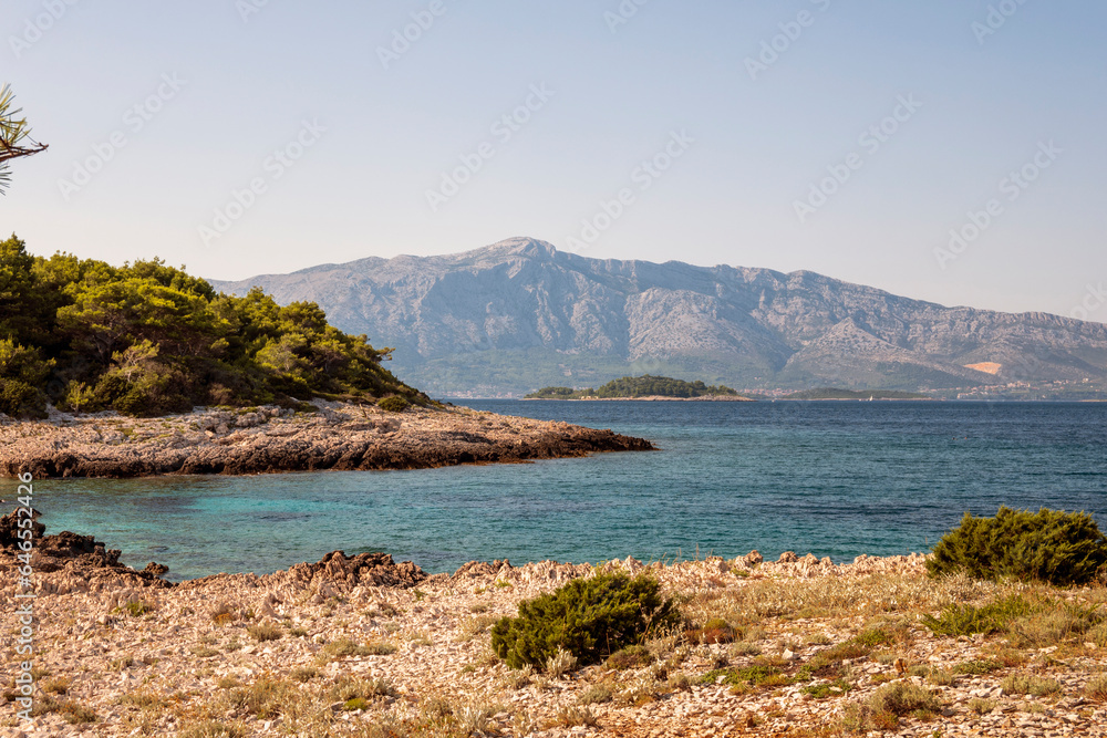 Isolated, hard approachable beaches with sharp rocks at cape Raznjic, on the far end of Korcula island, Croatia, overlooking Peljesac peninsula