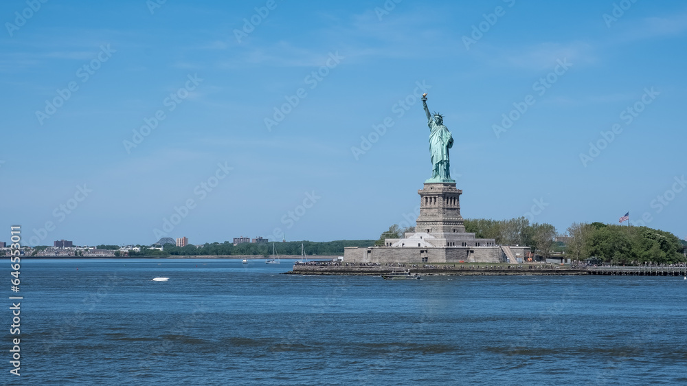 View of the Statue of Liberty, a colossal neoclassical sculpture on Liberty Island in New York Harbor in New York City, in the United States. View of the Statue of Liberty, a colossal neoclassical sculpture on Liberty Island in New York Harbor in New York City, in the United States.