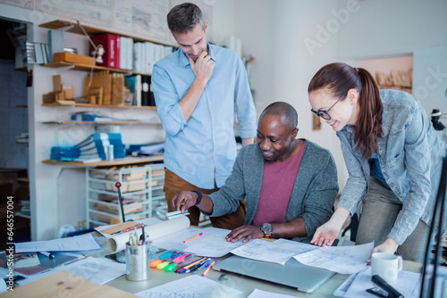 Diverse group of architects working together on a project in a startup company office