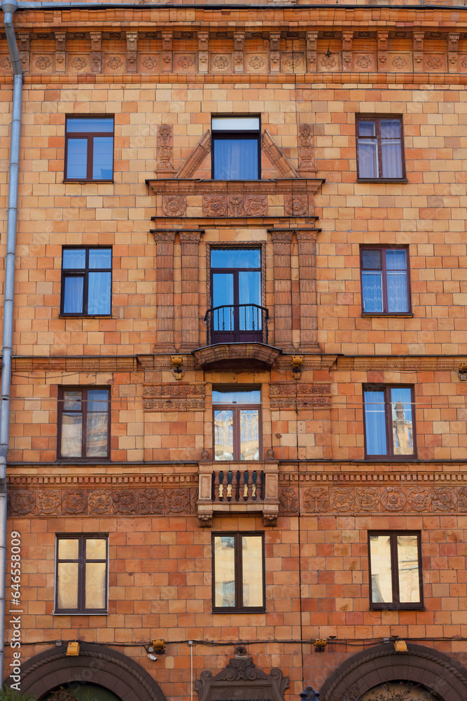 facade of an old brick building in the city center with evening light