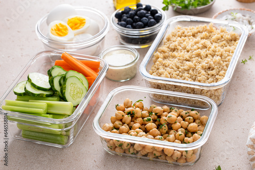 Vegetarian lunch meal prep in containers, high protein with quinoa, herbed chickpeas, vegetables and boiled eggs