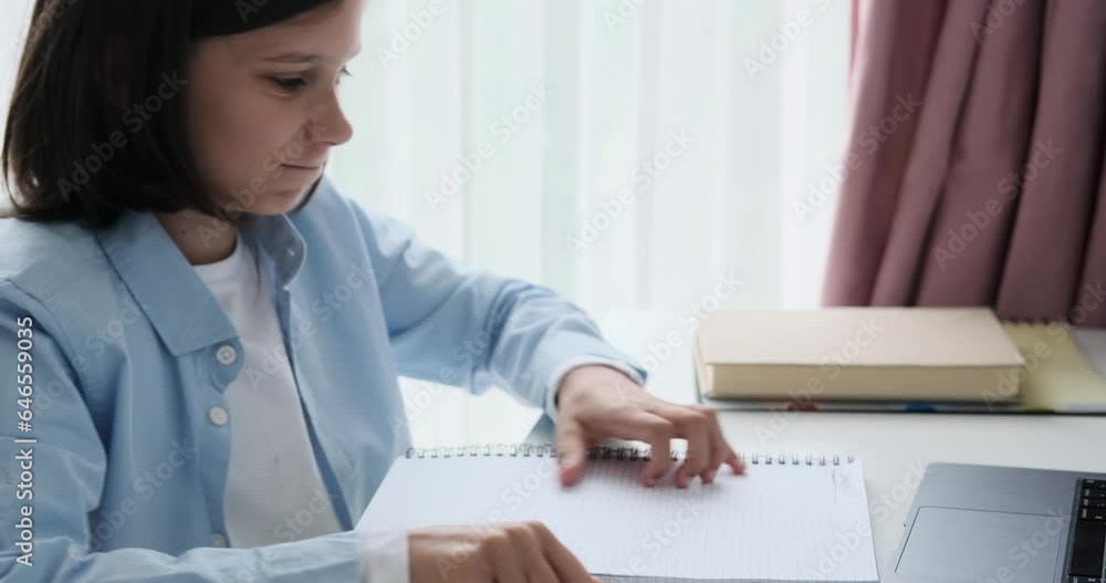 Disheartened boy rips pages from his notebook with frustration. His distressed expression and forceful actions reveal a moment of emotional turmoil, offering a glimpse into the challenges.