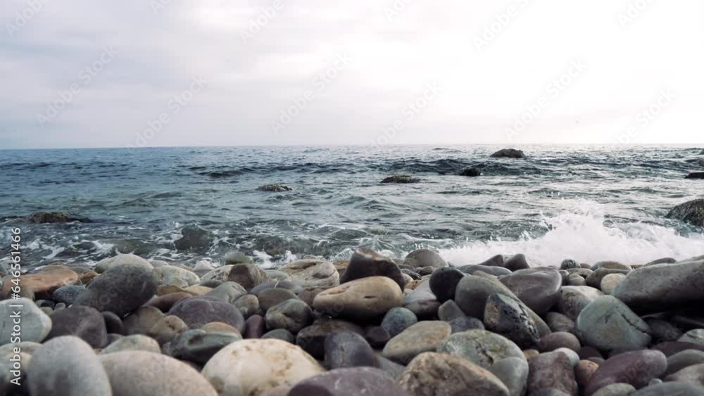 Gentle Mediterranean waves lap the stony shores of Port de Valldemossa's tranquil beach. Gentle Mediterranean waves lap the stony shores of Port de Valldemossa's tranquil beach.