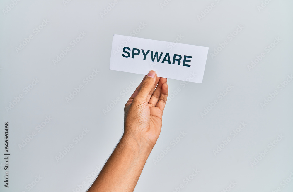 Hand of caucasian man holding paper with spyware word over isolated white background Hand of caucasian man holding paper with spyware word over isolated white background