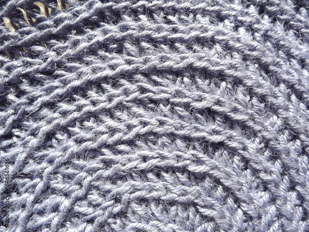 Crocheting of jute, yarn, raffia blue in a circle close-up as a background Crocheting of jute, yarn, raffia blue in a circle close-up as a background