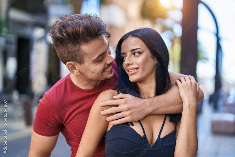 Man and woman couple smiling confident hugging each other at street Man and woman couple smiling confident hugging each other at street