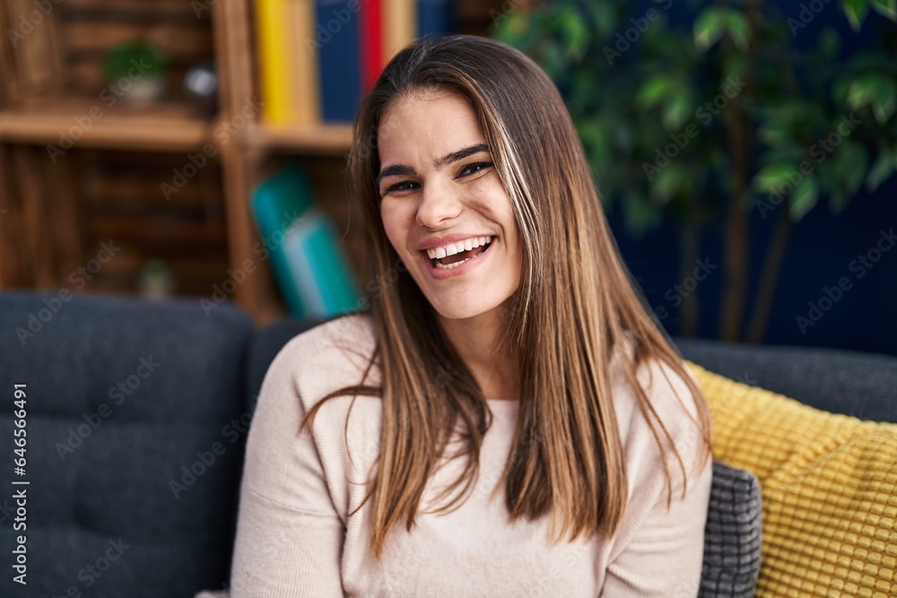 Young beautiful hispanic woman smiling confident sitting on sofa at home Young beautiful hispanic woman smiling confident sitting on sofa at home