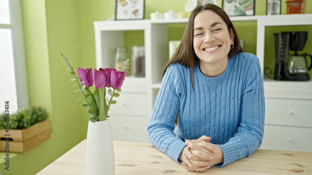 Young caucasian woman smiling confident sitting on table at dinning room Young caucasian woman smiling confident sitting on table at dinning room