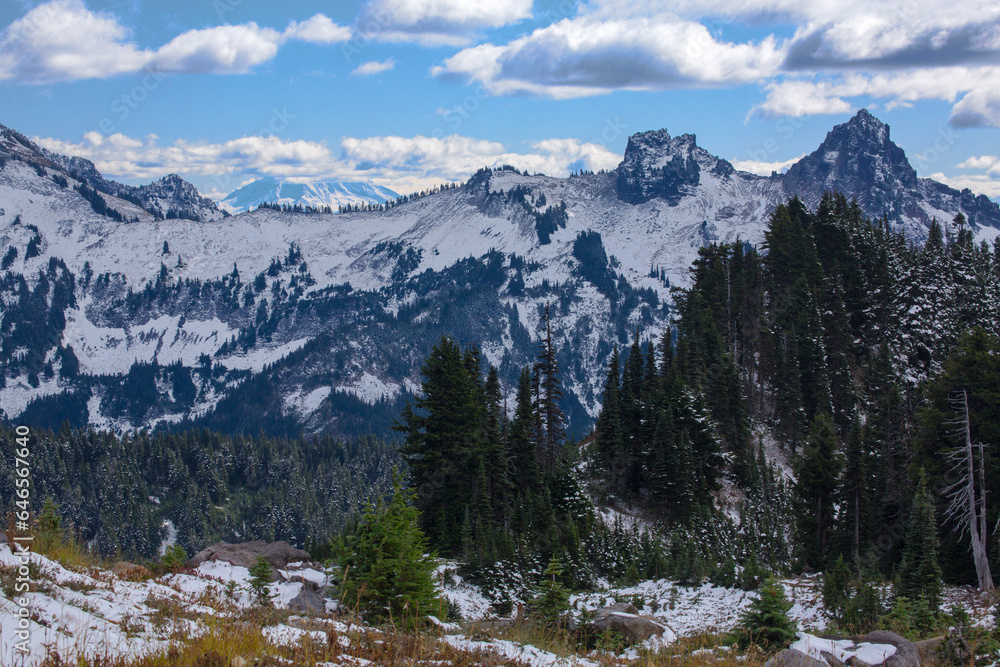 Snow-covered Tatoosh mountain range with Mt. St. Helens in the background at Mt. Rainier National Park in Washington state

