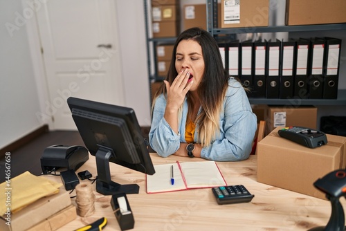 Young beautiful plus size woman ecommerce business worker yawning at office
