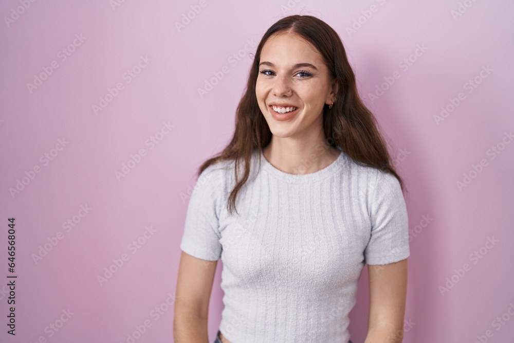 Young hispanic girl standing over pink background winking looking at the camera with sexy expression, cheerful and happy face. Young hispanic girl standing over pink background winking looking at the camera with sexy expression, cheerful and happy face.