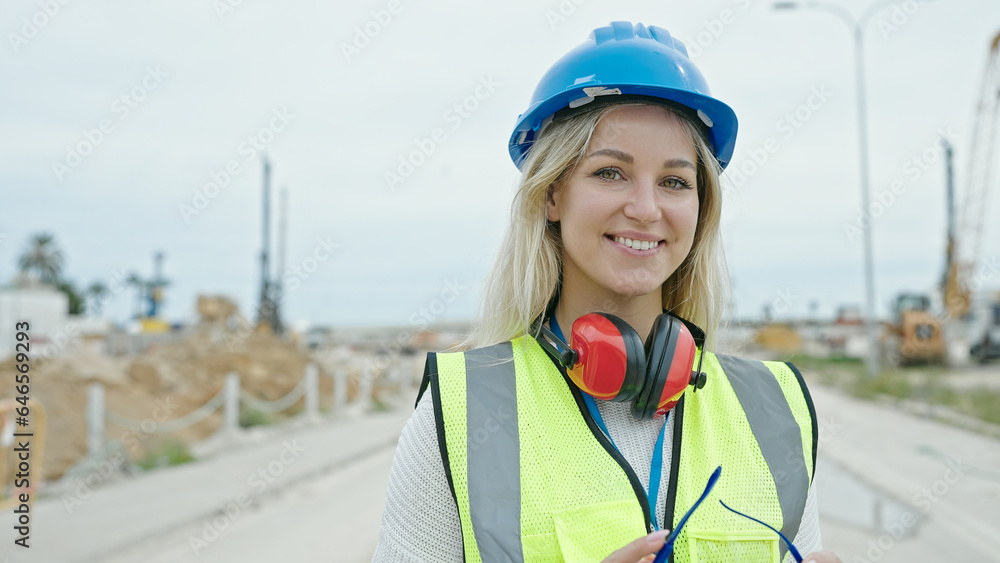 Young blonde woman architect smiling confident standing at street Young blonde woman architect smiling confident standing at street