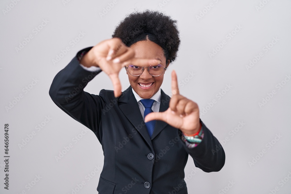 Beautiful african woman with curly hair wearing business jacket and glasses smiling making frame with hands and fingers with happy face. creativity and photography concept. Beautiful african woman with curly hair wearing business jacket and glasses smiling making frame with hands and fingers with happy face. creativity and photography concept.