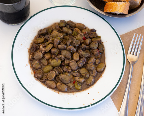 Stew of Habas with blood sausage served on white plate in restaurant