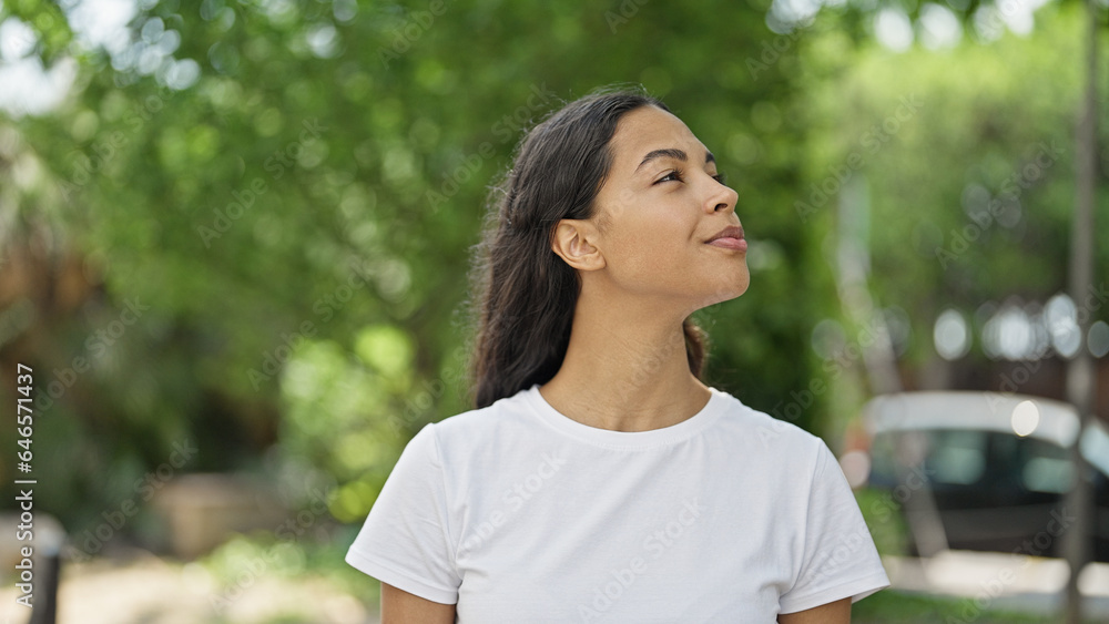 African american woman looking to the sky with serious expression at park African american woman looking to the sky with serious expression at park