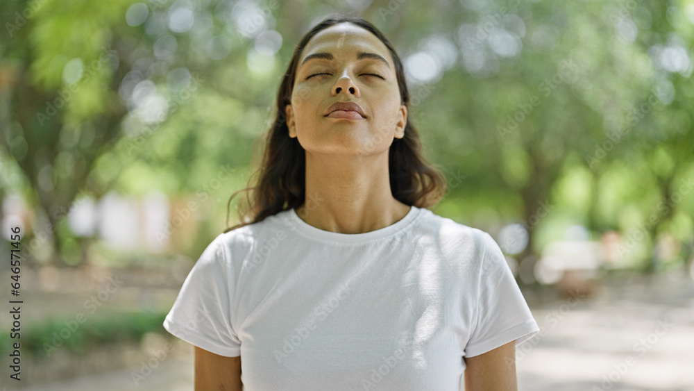 African american woman breathing with closed eyes at park African american woman breathing with closed eyes at park