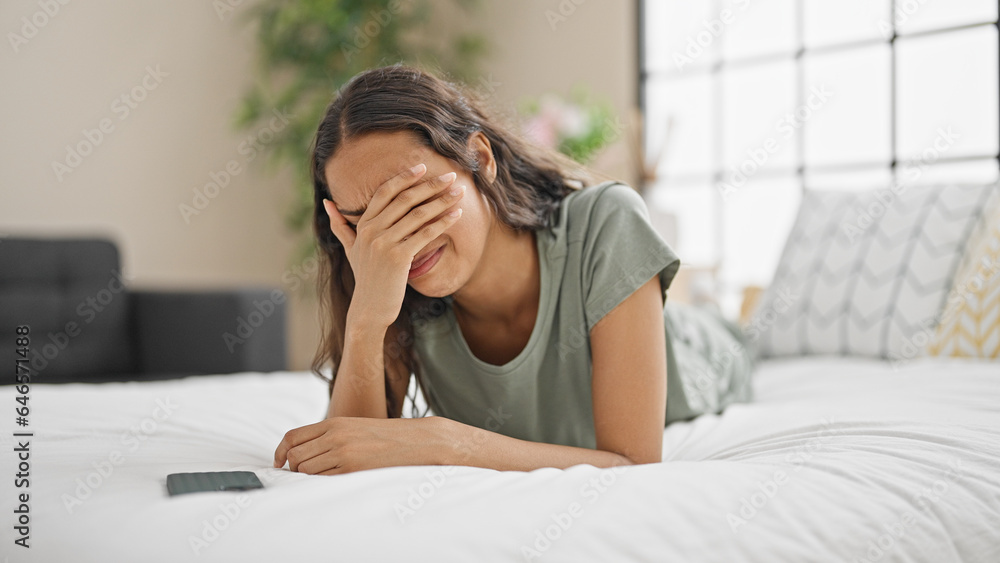 African american woman lying on bed with worried expression covering eyes at bedroom African american woman lying on bed with worried expression covering eyes at bedroom