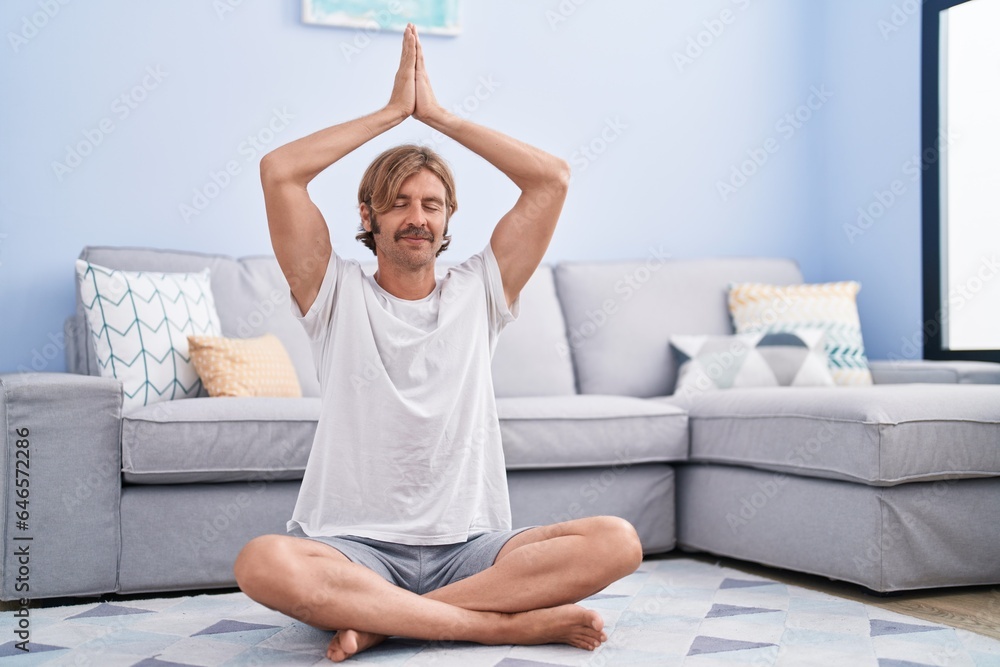 Young blond man smiling confident training yoga at home Young blond man smiling confident training yoga at home