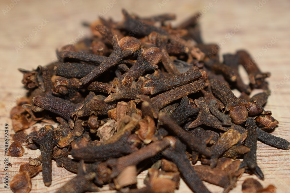 aromatic cloves close-up over a wooden table kitchen aromatic cloves close-up over a wooden table kitchen