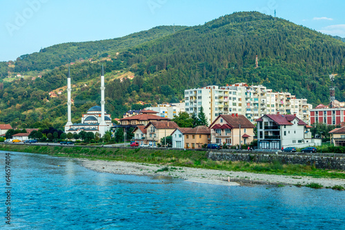 Gorazde residential district town panorama with mosque on the riverbank and Drina river in the foreground, Bosnia and Herzegovina photo