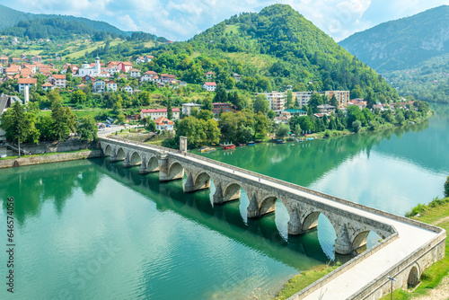 Mehmed Pasa Sokolovic Bridge over Drina river with city panorama, Visegrad, Bosnia photo