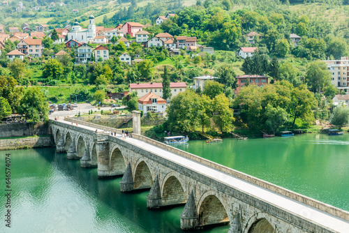 Mehmed Pasa Sokolovic Bridge over Drina river with city panorama, Visegrad, Bosnia photo