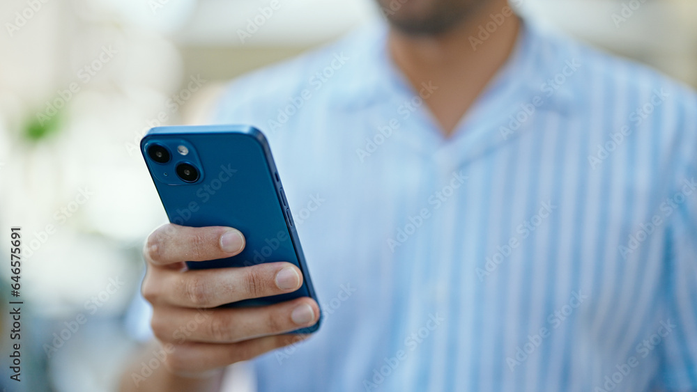 Young hispanic man using smartphone at street Young hispanic man using smartphone at street