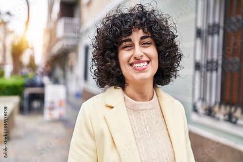 Young middle east woman excutive smiling confident standing at street photo
