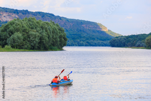People travel along the river in a kayak. Rafting as a healthy lifestyle. Background © Iurii Gagarin