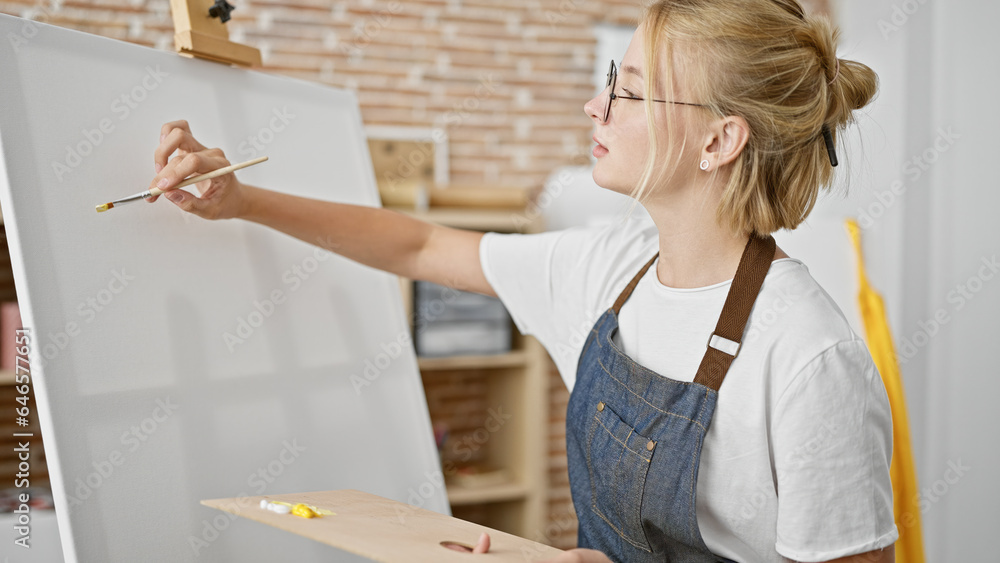 Young blonde woman artist drawing concentrated at art studio Young blonde woman artist drawing concentrated at art studio