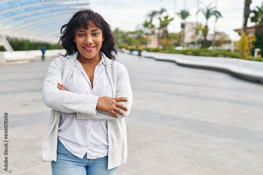Young beautiful latin woman standing with arms crossed gesture at park Young beautiful latin woman standing with arms crossed gesture at park