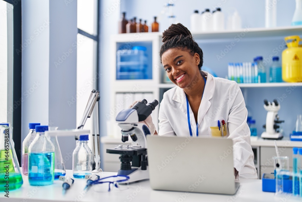 African american woman scientist using laptop working at laboratory African american woman scientist using laptop working at laboratory