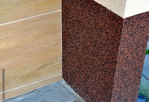 The foundation of the building is painted with a granite stone texture paint - liquid granite