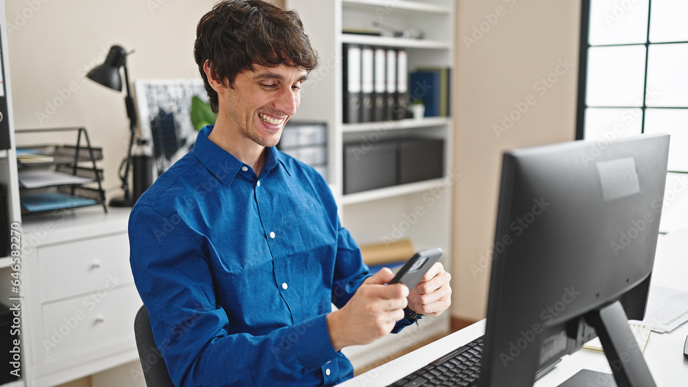 Young hispanic man business worker using computer and smartphone at the office Young hispanic man business worker using computer and smartphone at the office