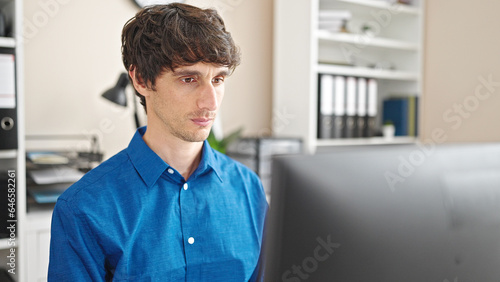 Young hispanic man business worker using computer working at the office