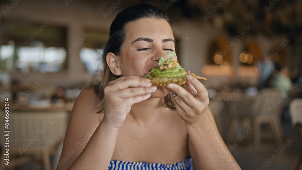 Young hispanic woman eating fusion food at the restaurant Young hispanic woman eating fusion food at the restaurant