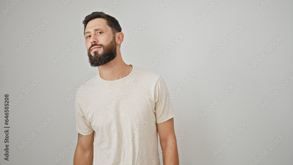 Young hispanic man looking for with serious expression over isolated white background Young hispanic man looking for with serious expression over isolated white background