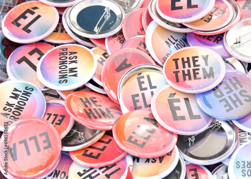фотографія Background of Gay Pride Pins, Ask Me my Pronouns in both English and Spanish for he, him, her, she, they, them