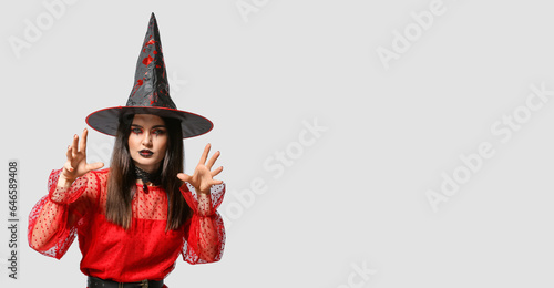 Beautiful woman dressed as witch for Halloween on light background with space for text