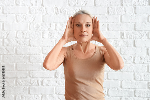 Mature woman doing face bui...