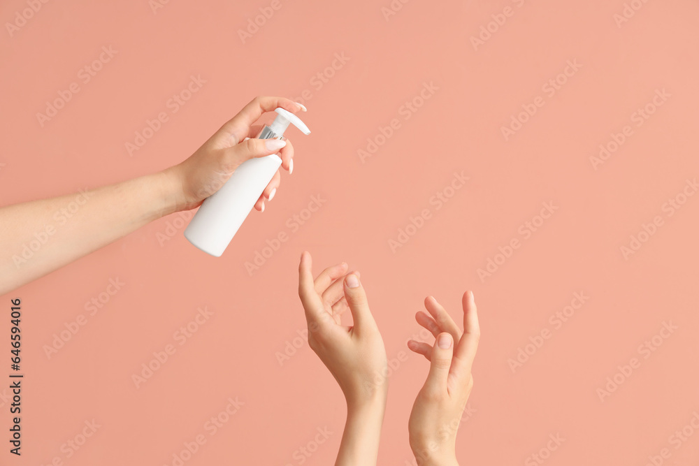 Female hands with bottle of sunscreen cream on color background Female hands with bottle of sunscreen cream on color background