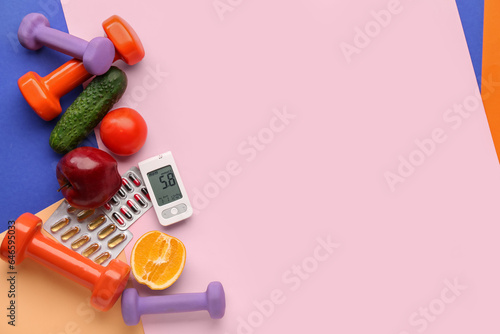 Glucometer with pills, food and dumbbells on color background. Diabetes concept